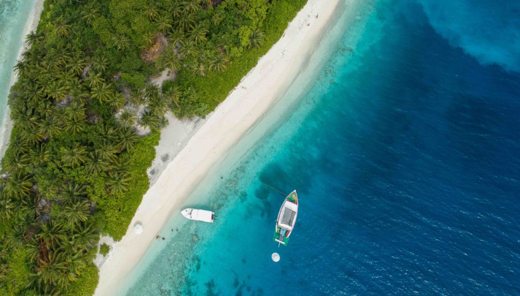 Maldives Island with boats at the beach