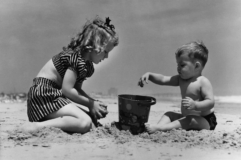 Vintage photo children playing in the sand at spring break